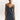 a woman modeling a deep blue slip dress with lace trim on a white studio backdrop