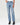Person wearing light blue jeans and black boots on a white background
