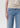 Light blue jeans worn by a person on a plain background