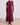Maroon long-sleeve dress with a knot detail on a plain background