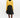 Woman wearing a yellow sweater and black skirt on a white background
