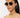 Woman wearing sunglasses with a plain background