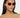 Woman wearing sunglasses with a plain background