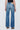 Blue jeans worn by a person on a light gray background