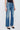 Person wearing blue jeans on a white background