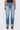Person wearing light blue jeans on a white background