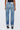 Person wearing light blue jeans on a white background