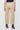 Beige pants worn by a person on a white background