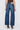 Blue jeans worn by a person on a white background