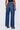 Person wearing blue jeans on a white background