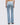Light blue jeans worn by a person on a white background