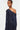 Navy blue one-shoulder dress worn by a model on a white background