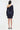 Navy one-shoulder dress worn by a model on a white background