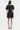 Black dress worn by a model on a white background