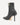 Black high-heeled ankle boot with a gold zipper on a white background